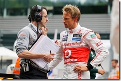 Jenson Button talks with engineer Dave Robson on the grid