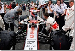 Jenson Button climbs in to his car on the grid