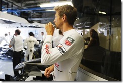Jenson Button has a coffee in the garage.